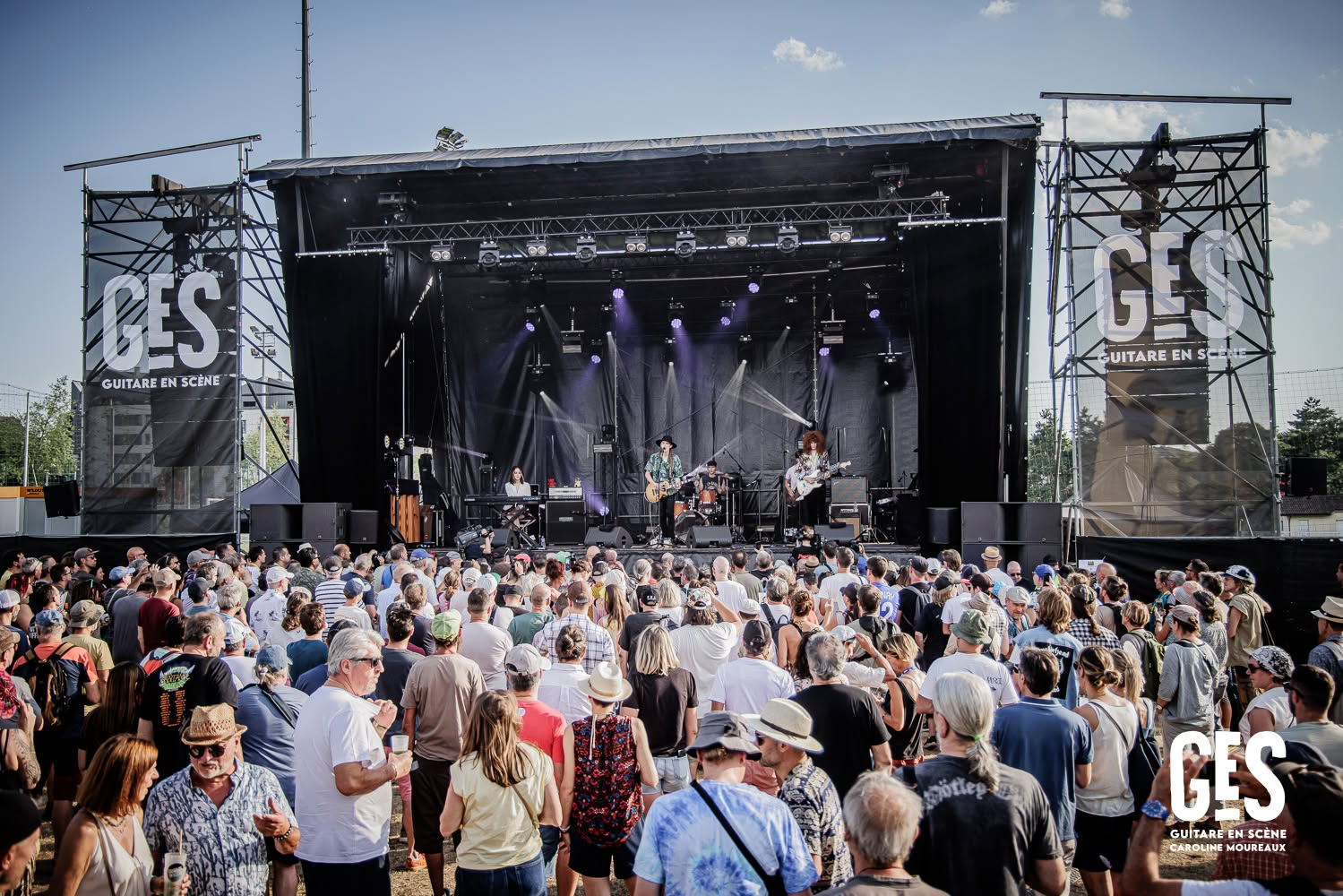 Taj Farrant's touring band performing before a large audience at Guitare en Scène in France